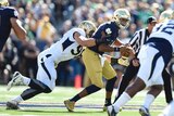Notre Dame quarterback DeShone Kizer (R) is chased by Georgia Tech defensive tackle Adam Gotsis.