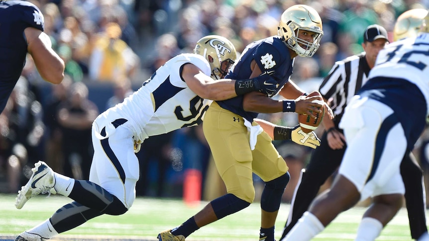 Notre Dame quarterback DeShone Kizer (R) is chased by Georgia Tech defensive tackle Adam Gotsis.