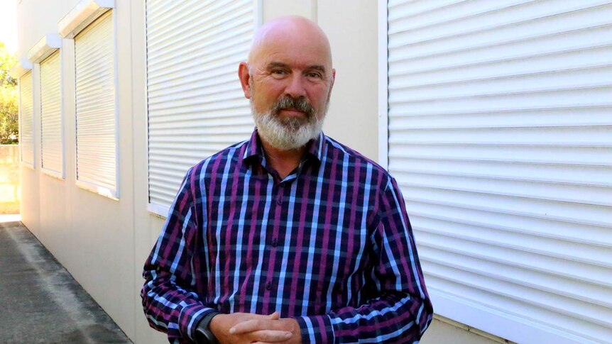 Drug policy expert Steve Allsop stands in front of some windows at Curtin University.