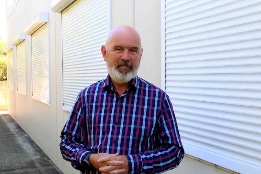 Drug policy expert Steve Allsop stands in front of some windows at Curtin University.