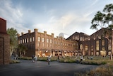Concept design for Powerhouse Museum with brick building, greenery and people walking on a footpath