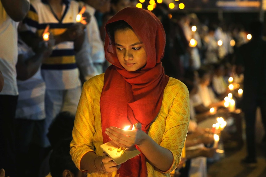 Pro-democratic Sri Lankans take part in a candle light vigil in Colombo