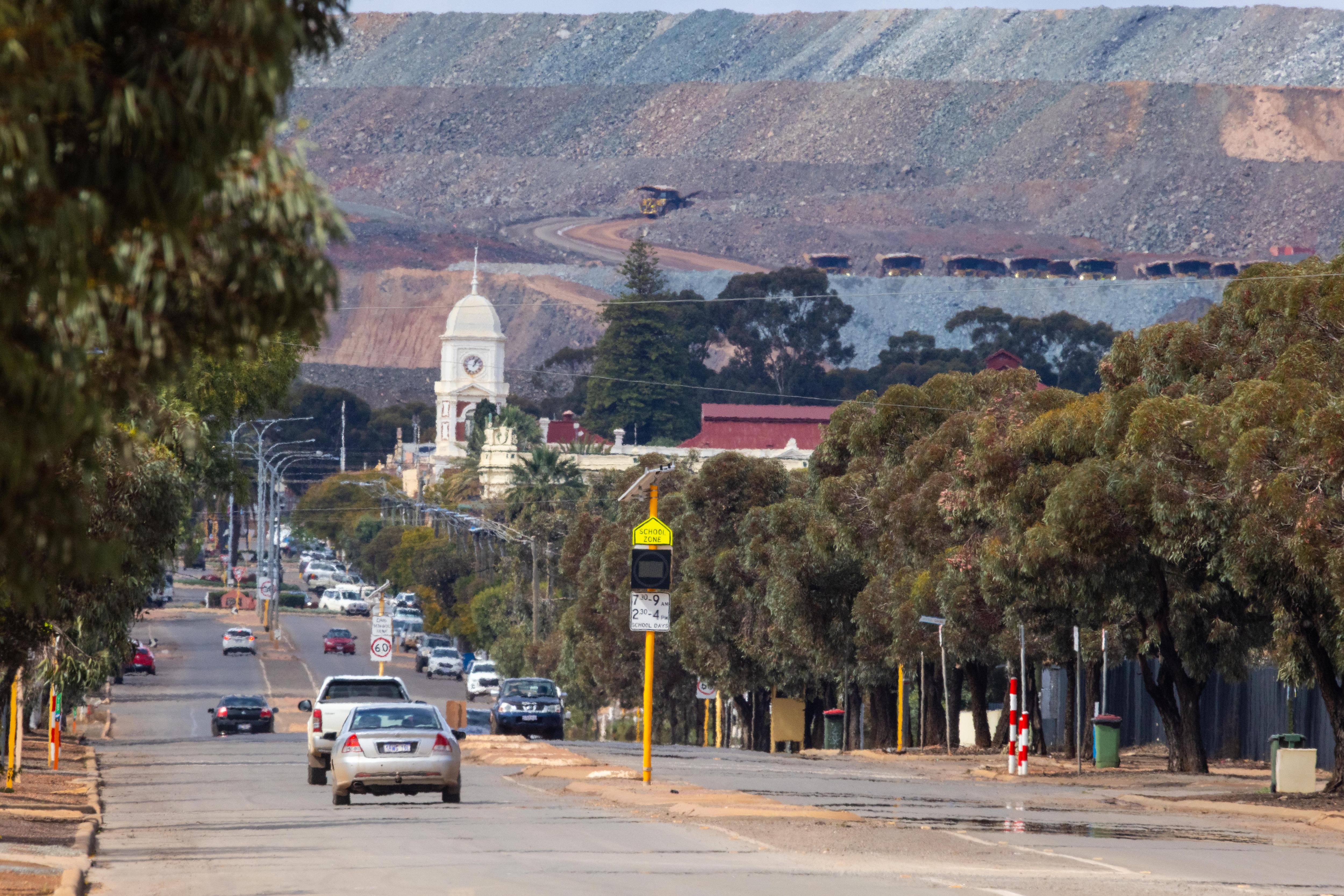 Long shot of Burt Street in Boulder with the Kalgoorlie super pit in the background.