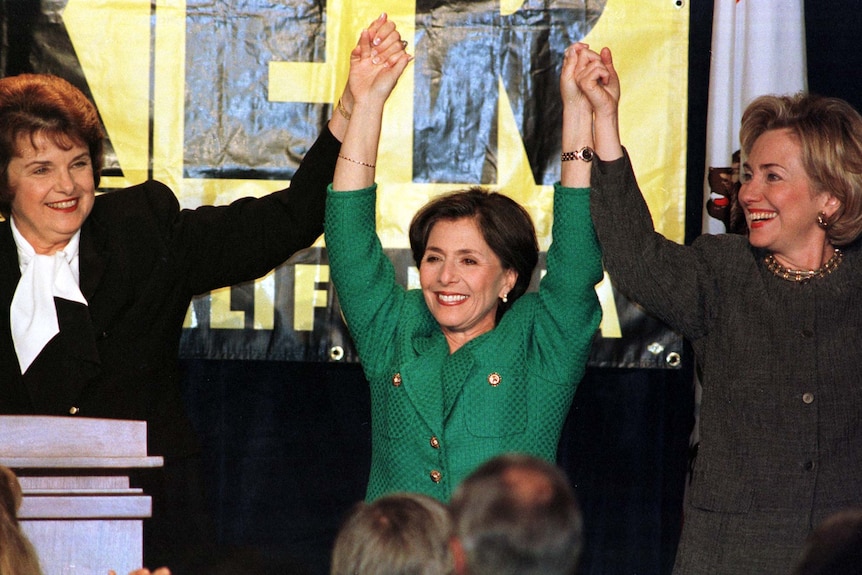 Dianne Feinstein, Barbara Boxer and Hillary Clinton holding hands in victory