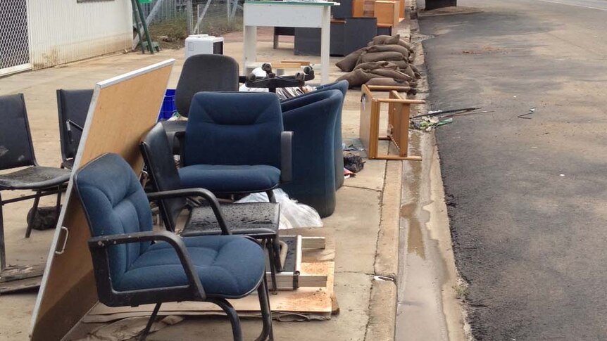 Discarded furniture litters a street in Mitchell