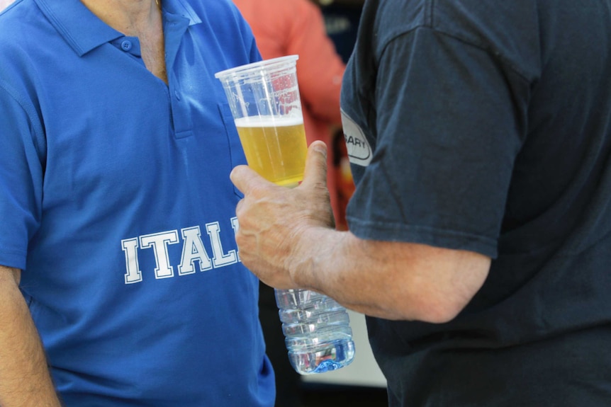 A man holds a beer at the National Multicultural Festival.