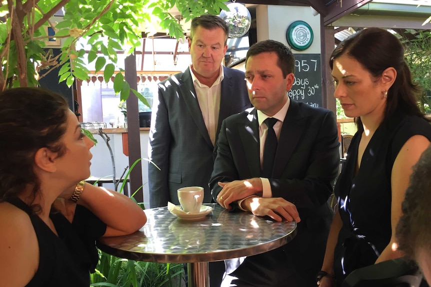Matthew Guy, his wife Renae and candidate Michael Lamb talk to cafe owner Mariam Jamil.