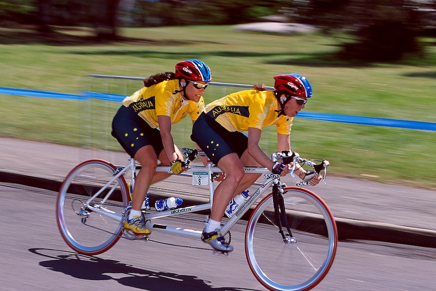 Lynette on a tandem bicycle during a race