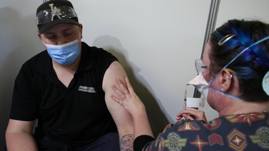 A person receives a COVID-19 vaccination.