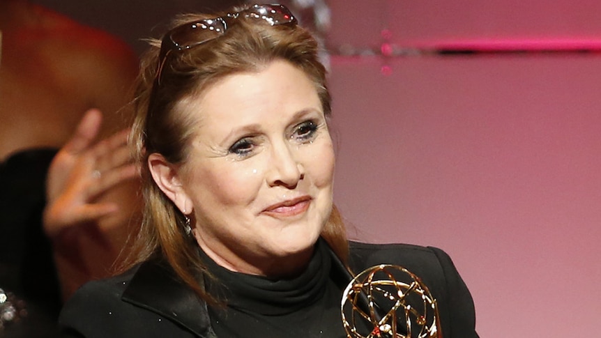 Carrie Fisher pictured with an award in 2013