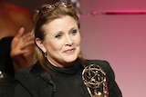 Carrie Fisher pictured with an award in 2013