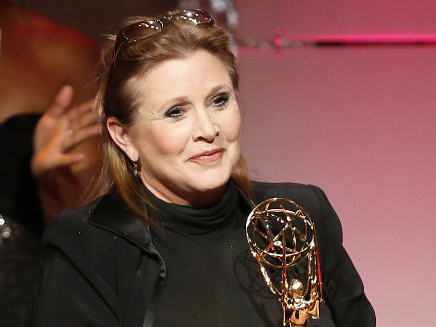 Carrie Fisher pictured with an award in 2013