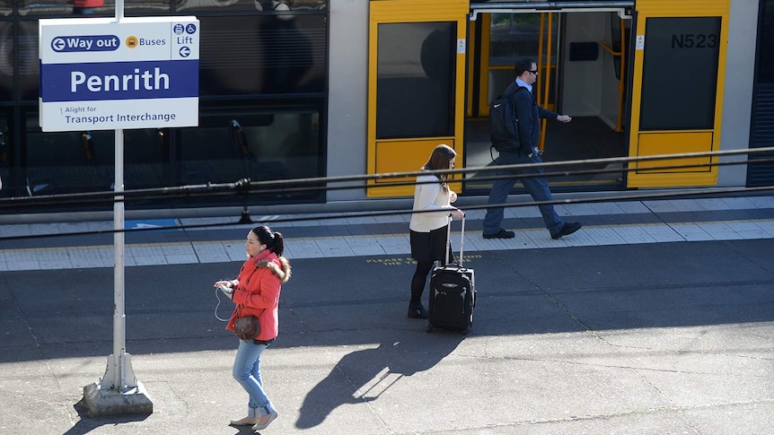 People walking at a train station.