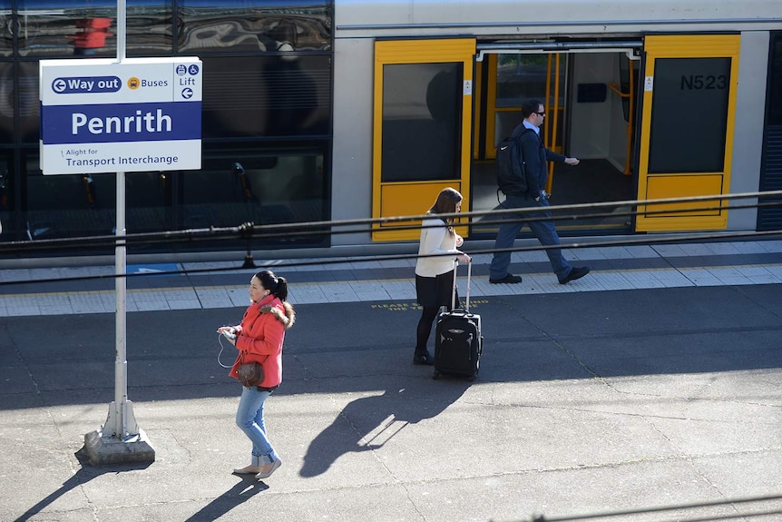 People walking at a train station.