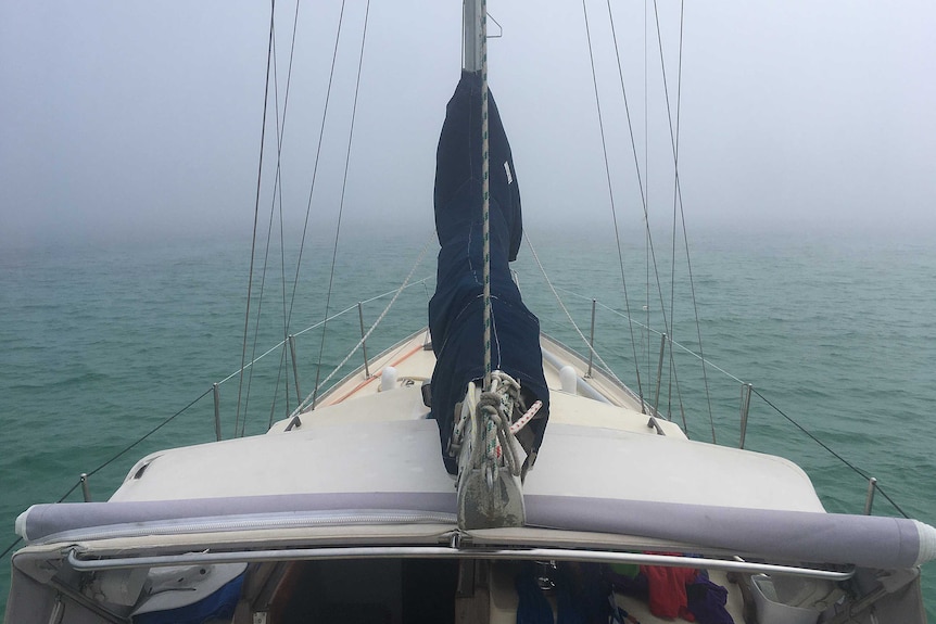 The bow of a boat on a foggy sea