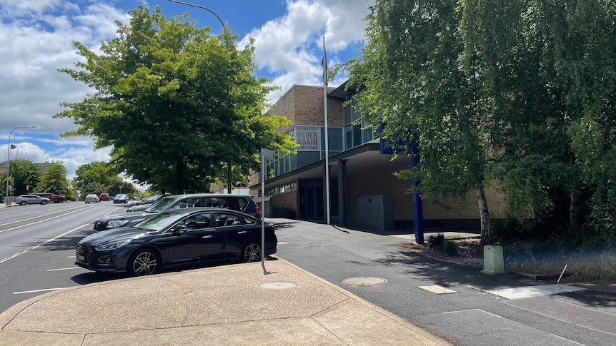 The outside of a police station on a busy street