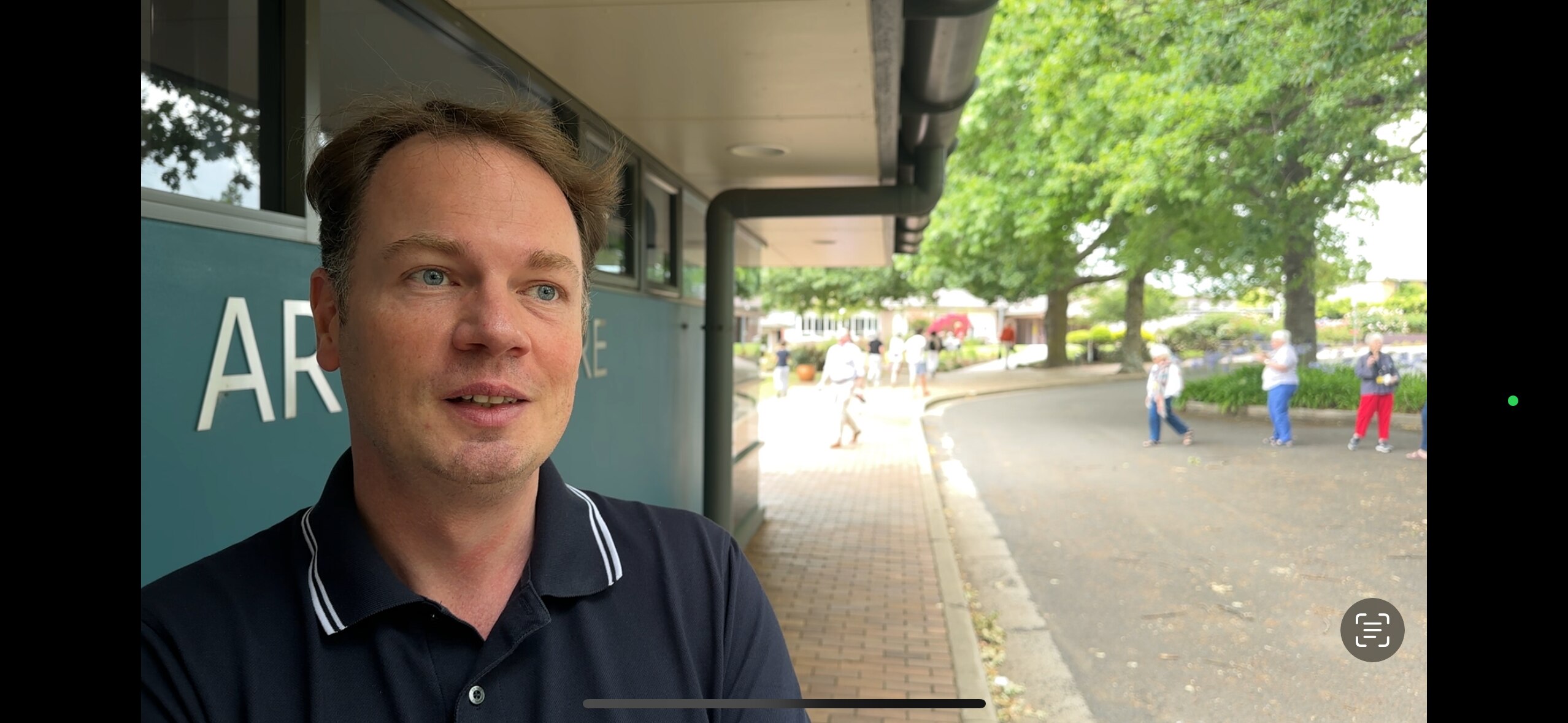 Close up of young man with pavement in the background