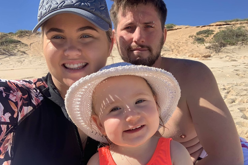 A selfie shot of Cleo Smith flanked by mother Ellie Smith and stepfather Jake Gliddon at the beach.
