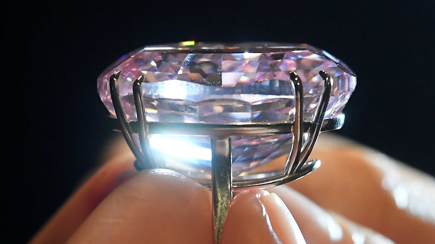A closeup of the "Pink Diamond" being held.