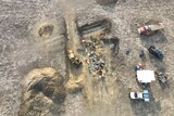 A drone overhead shot of a dusty dig site