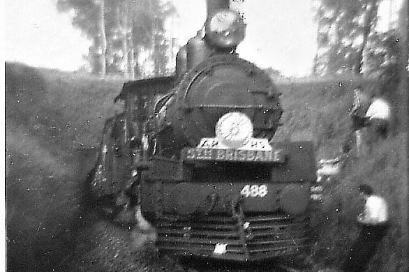 A black-and-white image of a steam train exiting the Ernest Junction railway tunnel.