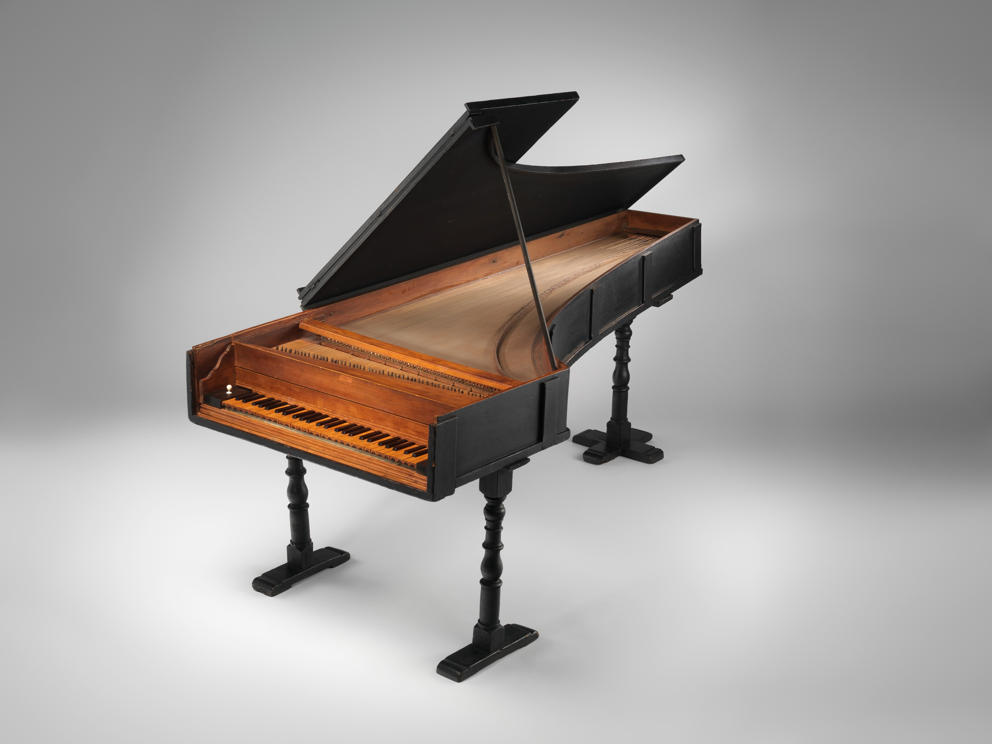 A photo of a 1720 grand piano by Bartolomeo Cristofori on a plain white background.