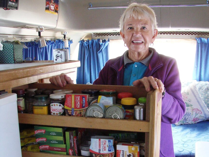 Judy Kendrick shows off her kitchen cupboard in her motorhome she owns with her husband Mike
