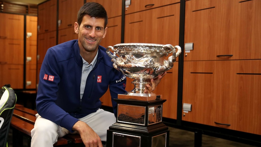 Serbia's Novak Djokovic poses with the Norman Brookes Challenge Cup after his Australian Open win.