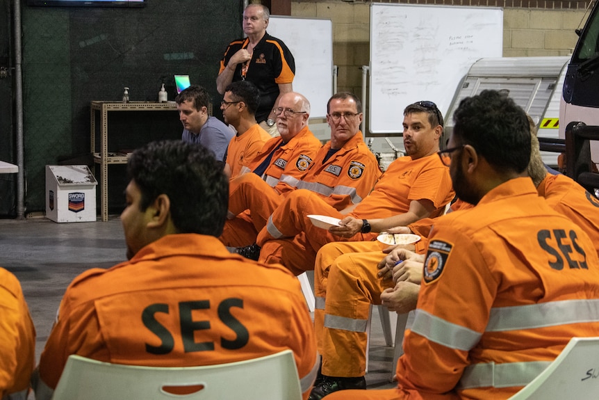 SES volunteers sit in for a meeting at the communications centre
