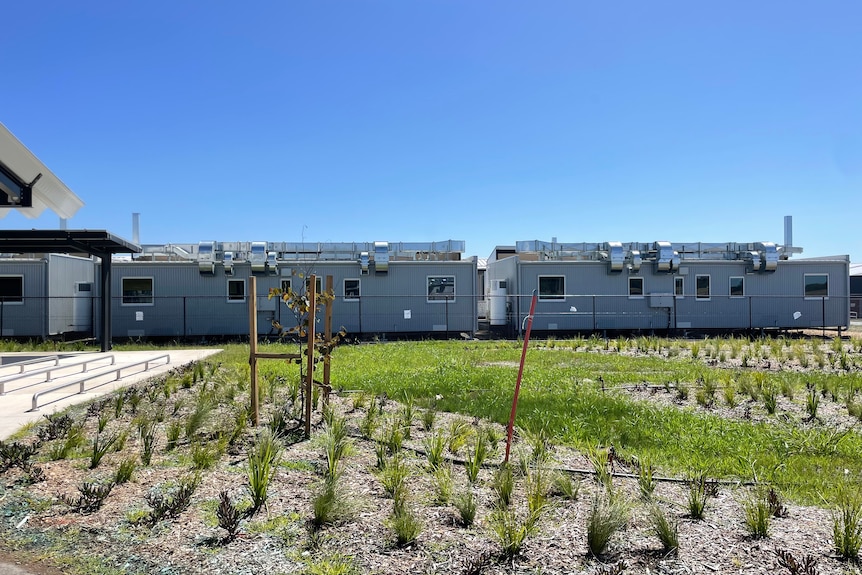 An outdoor walkway near cabins designed for quarantine