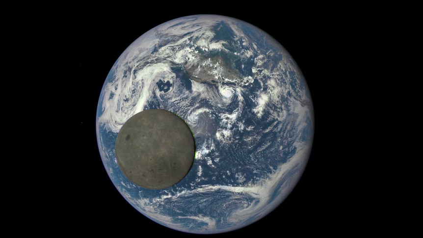 The far side of the moon, illuminated by the sun and the Earth