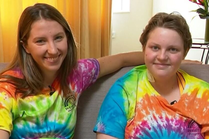 Amy Parmenter and Molly Croft smile while wearing tie-dye t-shirts
