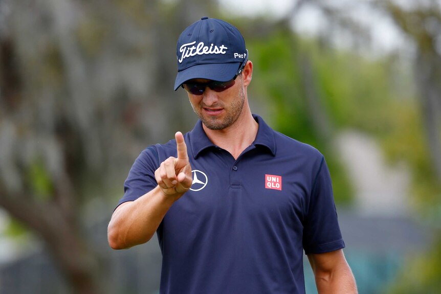 Adam Scott signals at the Arnold Palmer Invitational