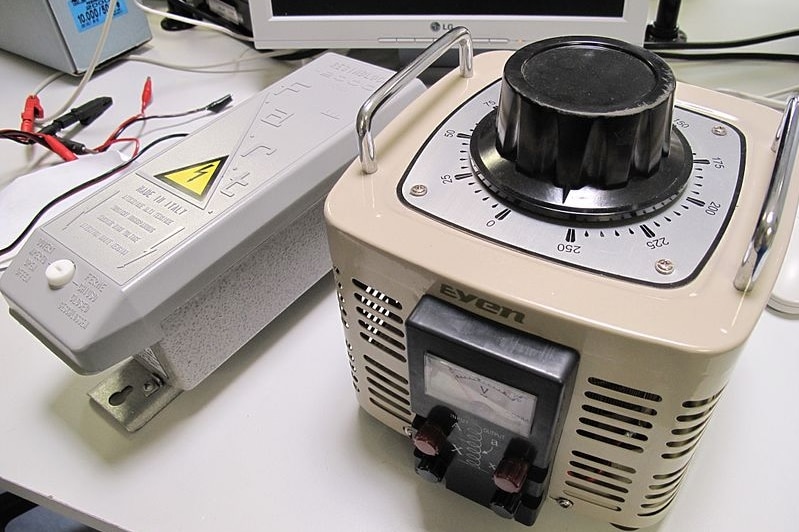 A Variac machine sits on a benchtop.