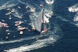 Wild Oats XI in surrounded by boats as it wins line honours in 2014