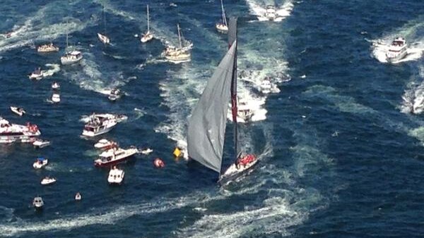 Wild Oats XI in surrounded by boats as it wins line honours in 2014