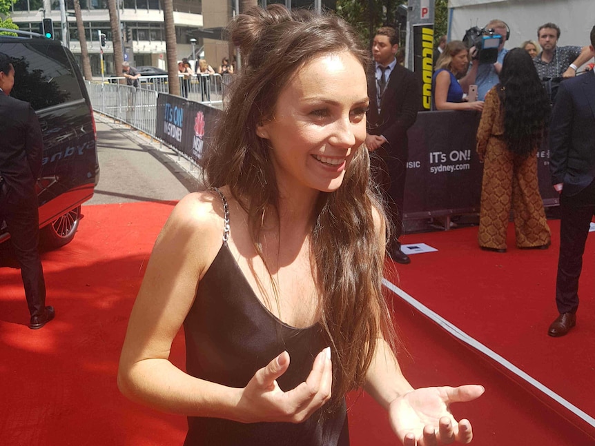 Young woman on red carpet.