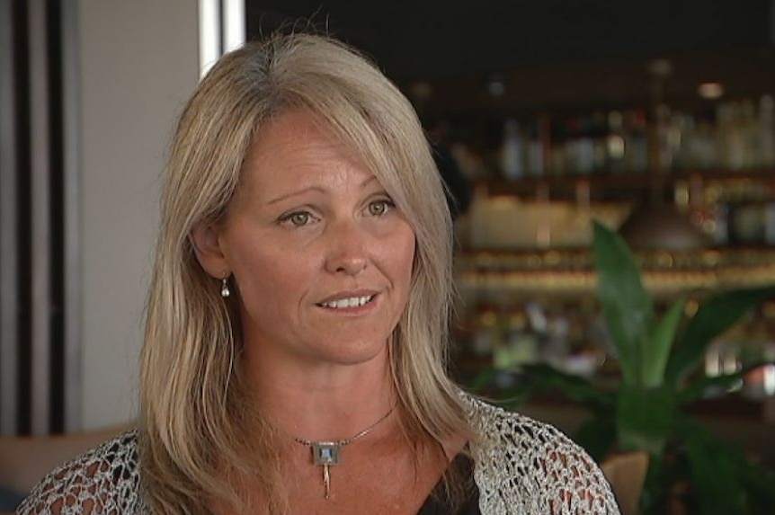 A blonde woman sits for an interview.