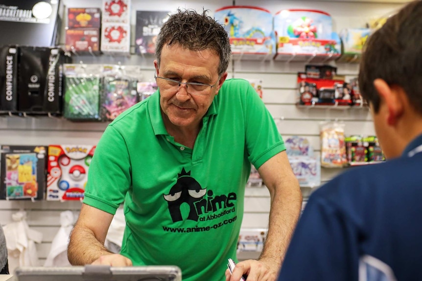 man behind the cashier of a toy store