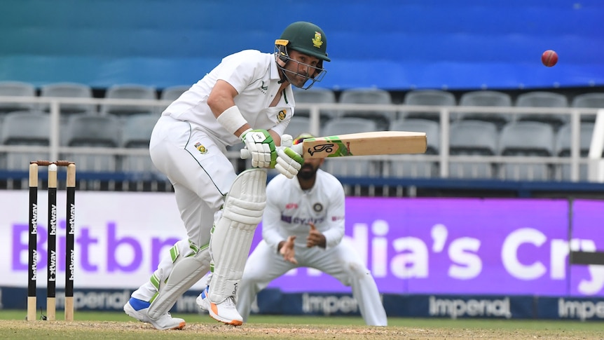 A batsman eyes the ball after playing a shot. 