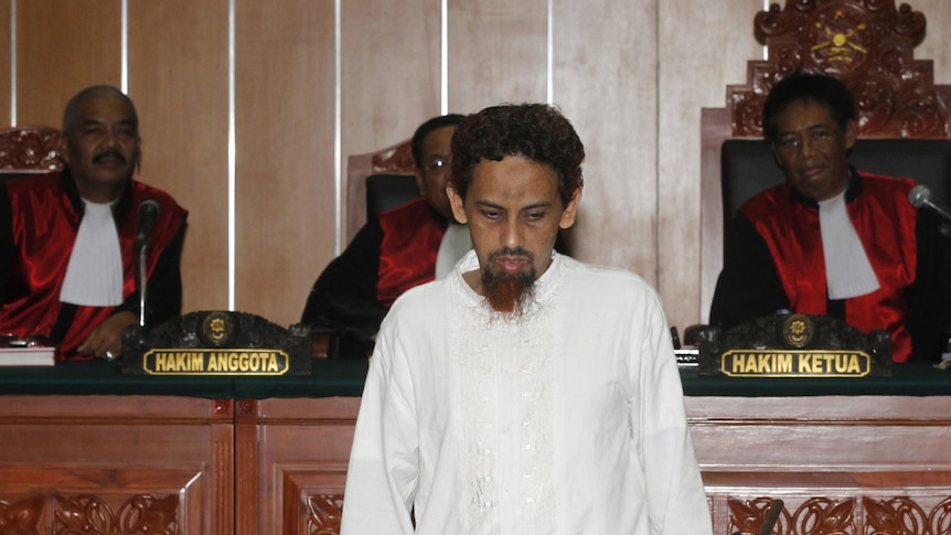 Umar Patek leaves a West Jakarta court after being found guilty and sentenced to 20 years in prison on June 21, 2012.