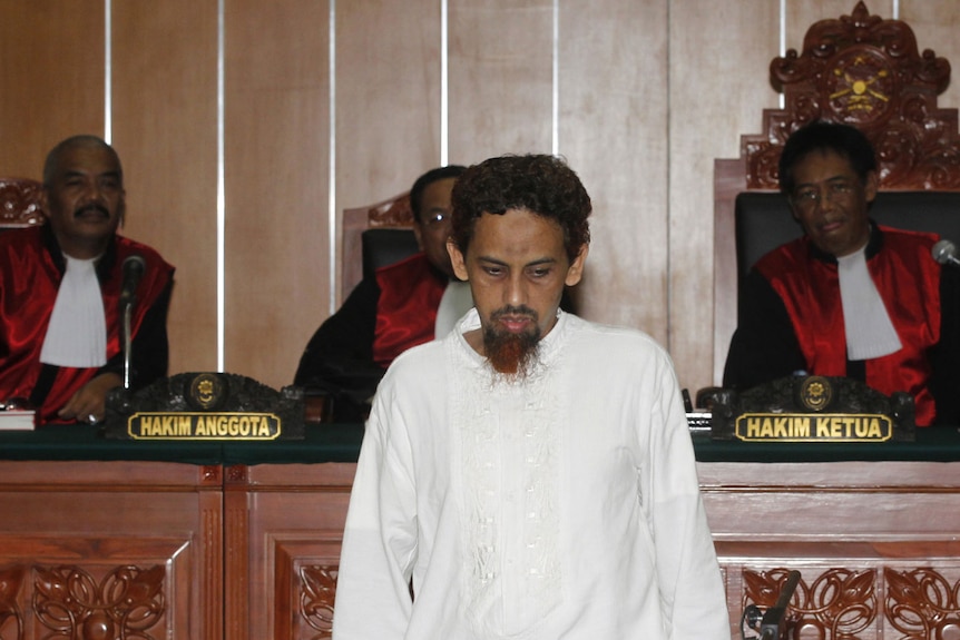 Umar Patek leaves a West Jakarta court after being found guilty and sentenced to 20 years in prison on June 21, 2012.