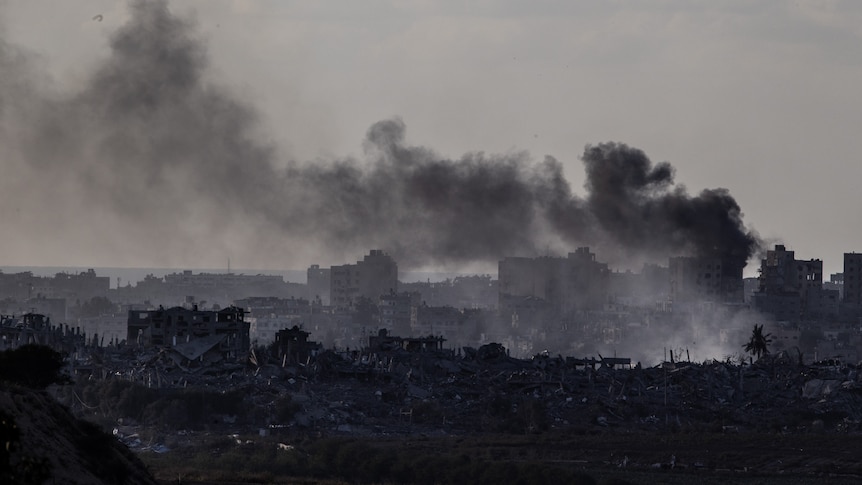 Smoke rising in Gaza amongst run down buildings