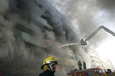 The twin bomb attack in a Baghdad market sent fire through a nearby building.