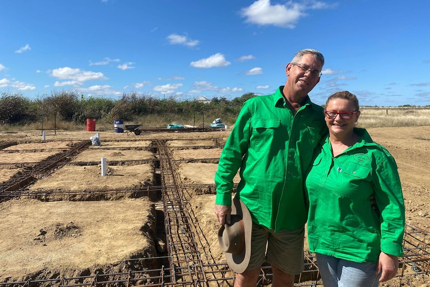 Greg Emmert and Louise Busby standing in front of the foundations for their on-farm abattoir.