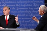 Democrat Tim Kaine (left) and Republican Mike Pence discuss an issue with their hands raised during a VP debate.
