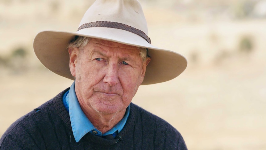 A headshot of a male farmer wearing a wide-brim hat