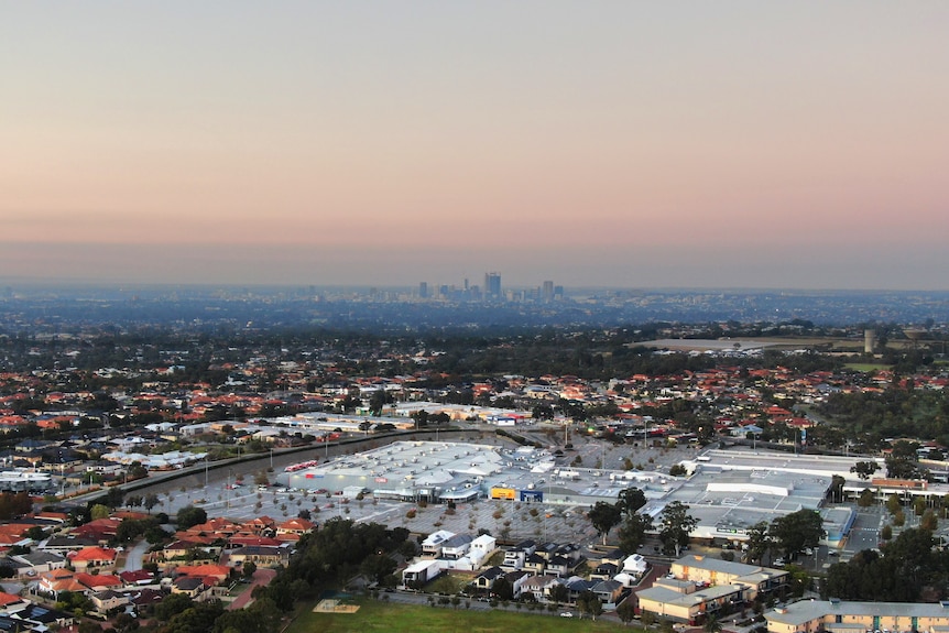 A shot of a city skyline taken from several kilometres away on a smoky morning