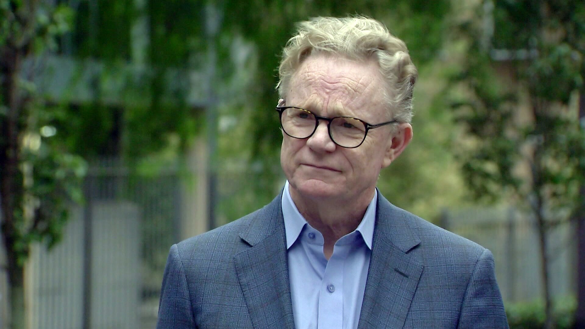 Hugh Riminton a journalist with channel ten is interviewed outdoors about the death of his colleague Jesse Baird