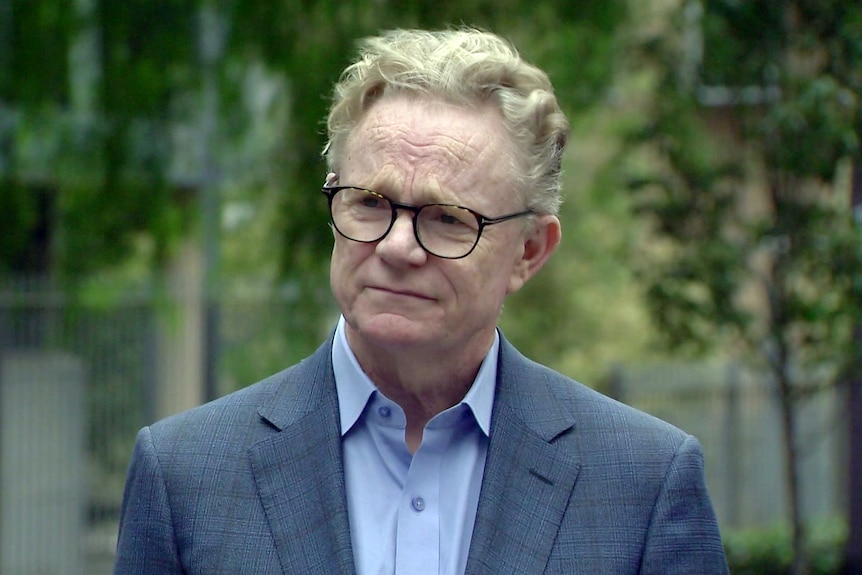 Hugh Riminton a journalist with channel ten is interviewed outdoors about the death of his colleague Jesse Baird